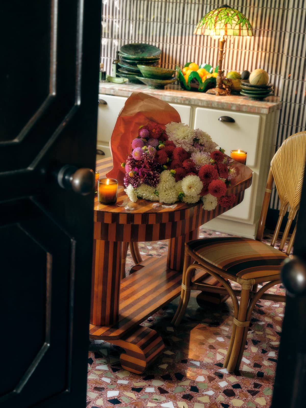 Open Door Into A Room With Fresh Flowers On A Table