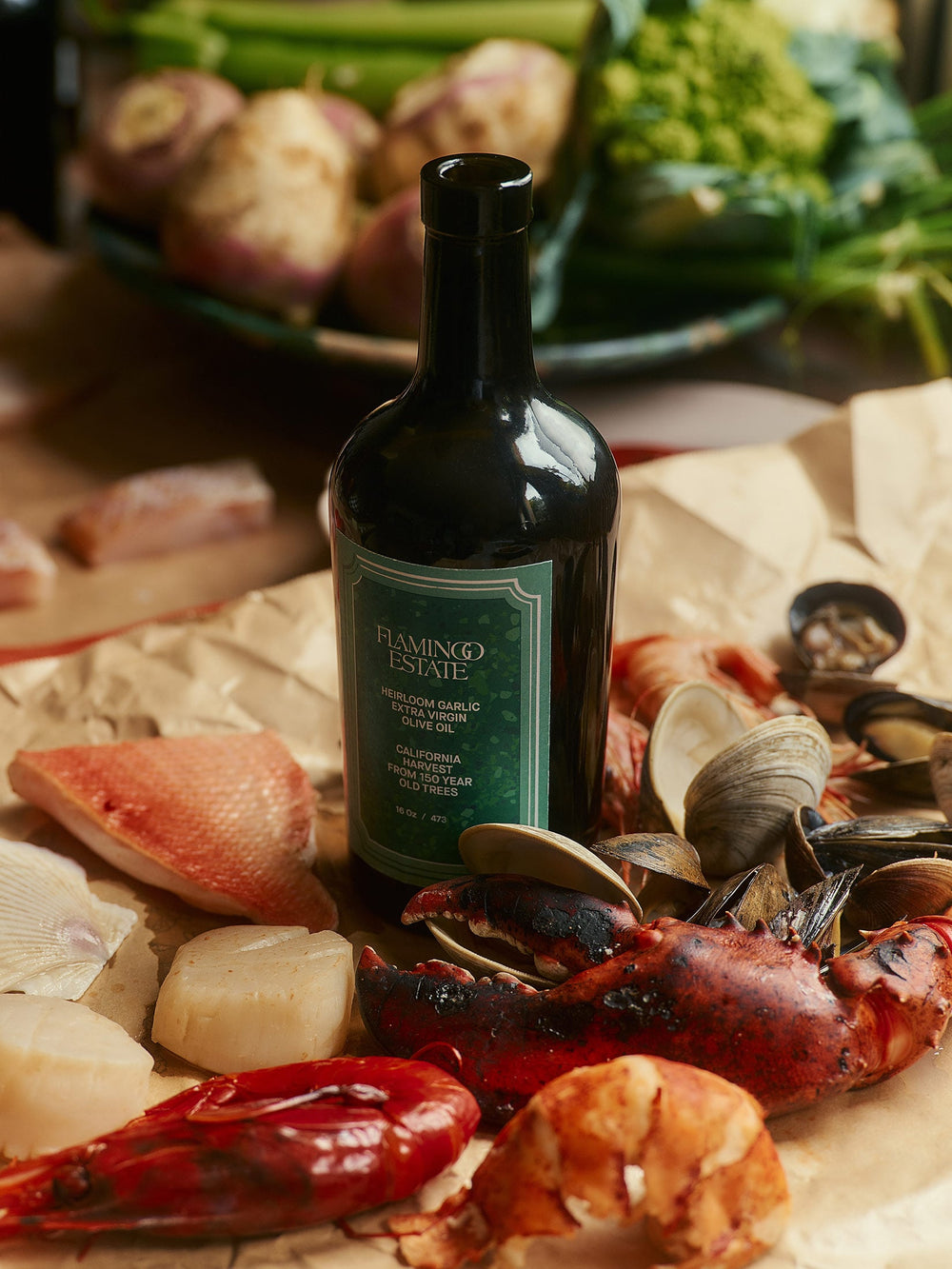 Garlic Infused Olive Oil bottle beside a gourmet seafood dish with shrimp and herbs.