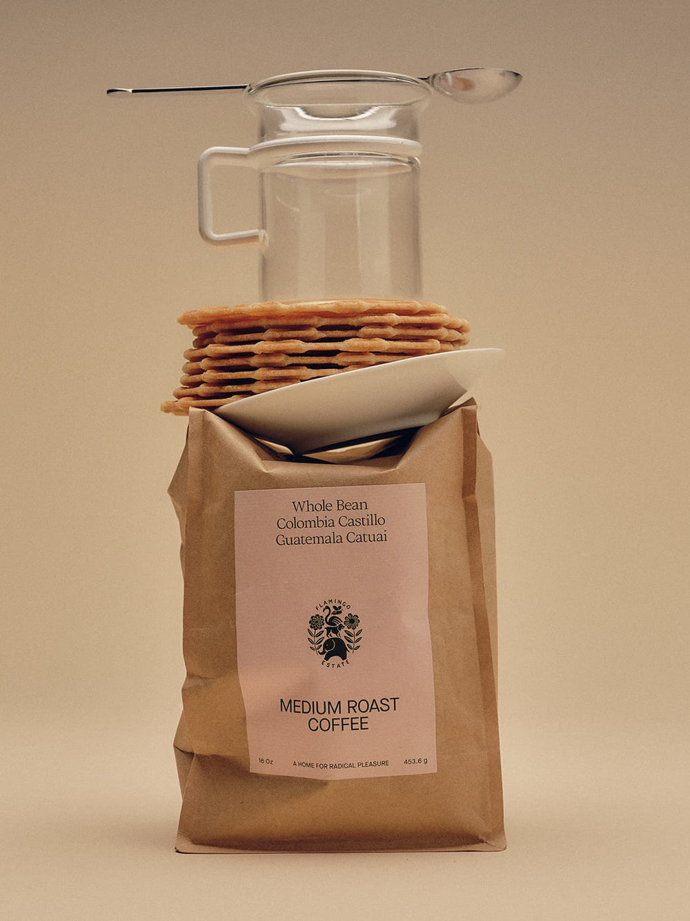 Bag Of Medium Roast Coffee With Coffee Accessories Balanced On Top