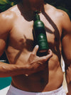 Man Holding A Bottle Of 