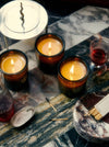 Lit Flamingo Estate Candle On A Marble Surface With A Box Of Matches
